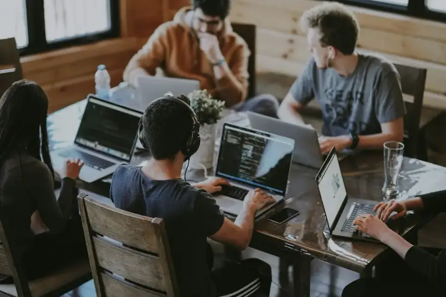 Team working together at a table with laptops