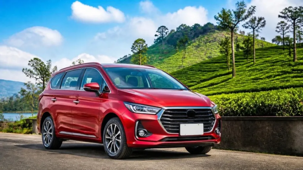 Illustration of a red 7-seater MPV beside a hillside tea plantation