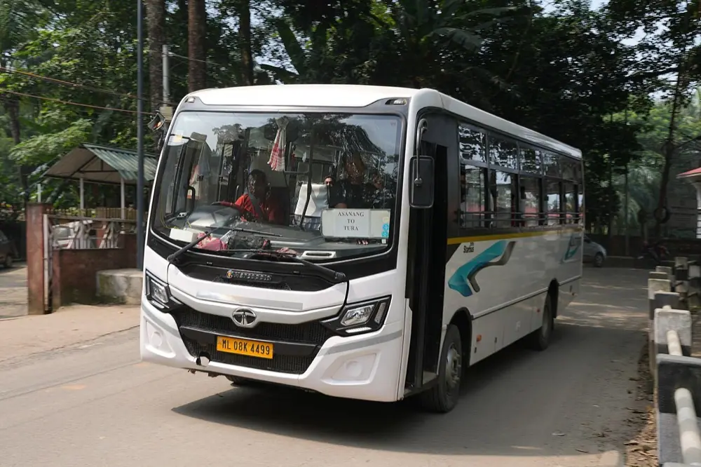 White mini bus on a tree-lined road (representative photo)